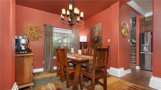 dining room featuring a notable chandelier, dark hardwood / wood-style floors, and crown molding