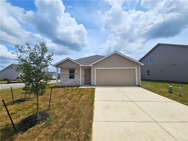 view of front of home with a front lawn and a garage