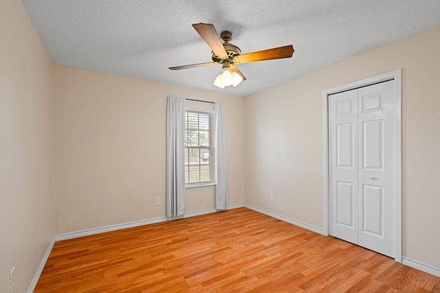 3605 Rushing Blvd, Corpus Christi, TX 78410 - unfurnished bedroom featuring light wood-style floors, baseboards, a textured ceiling, a ceiling fan, and a closet