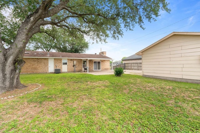3605 Rushing Blvd, Corpus Christi, TX 78410 - rear view of house featuring a patio area, a chimney, brick siding, and cooling unit