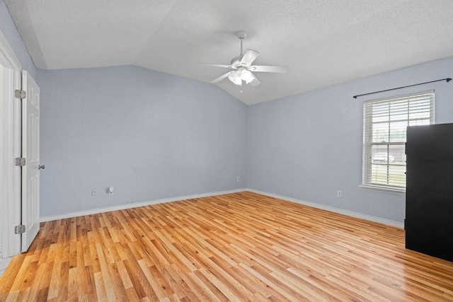3605 Rushing Blvd, Corpus Christi, TX 78410 - unfurnished bedroom with light wood-style floors, vaulted ceiling, a textured ceiling, baseboards, and ceiling fan