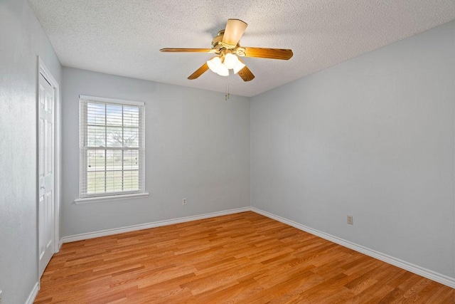 3605 Rushing Blvd, Corpus Christi, TX 78410 - unfurnished room with light wood finished floors, a textured ceiling, a ceiling fan, and baseboards