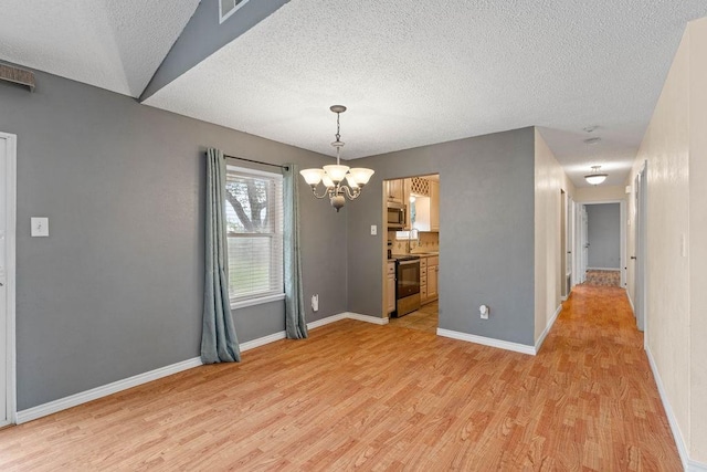 3605 Rushing Blvd, Corpus Christi, TX 78410 - unfurnished room featuring light wood-type flooring, a textured ceiling, a chandelier, and baseboards