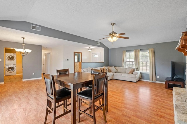 3605 Rushing Blvd, Corpus Christi, TX 78410 - dining area featuring stacked washer / dryer, lofted ceiling, light wood-style floors, ceiling fan, and a textured ceiling