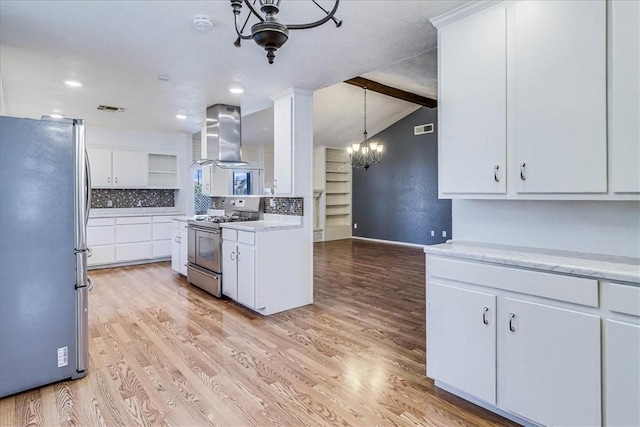10502 Hemlock Rd, Corpus Christi, TX 78410 - kitchen with appliances with stainless steel finishes, a chandelier, wall chimney exhaust hood, light countertops, and decorative backsplash