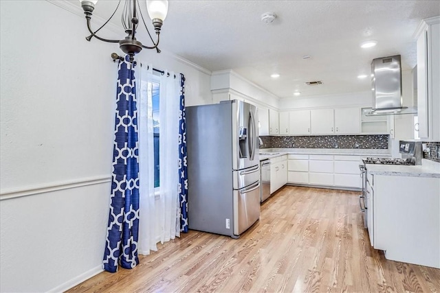 10502 Hemlock Rd, Corpus Christi, TX 78410 - kitchen featuring appliances with stainless steel finishes, ventilation hood, light countertops, and light wood-style flooring
