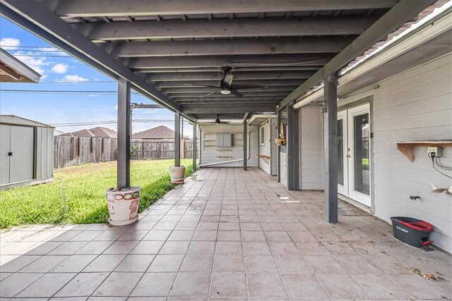 10502 Hemlock Rd, Corpus Christi, TX 78410 - fenced backyard featuring a patio, a storage shed, french doors, and a ceiling fan