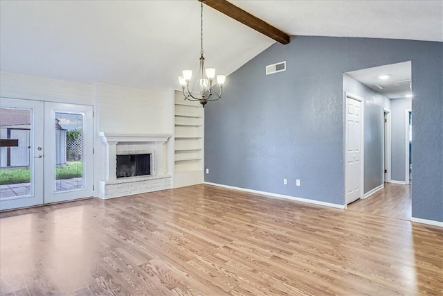 10502 Hemlock Rd, Corpus Christi, TX 78410 - unfurnished living room featuring wood finished floors, a chandelier, french doors, and built in shelves