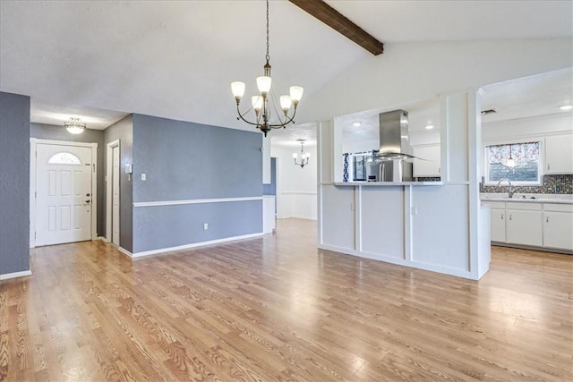 10502 Hemlock Rd, Corpus Christi, TX 78410 - kitchen with a chandelier, island range hood, white cabinetry, and light wood-style flooring