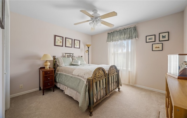 bedroom with baseboards, light carpet, and ceiling fan