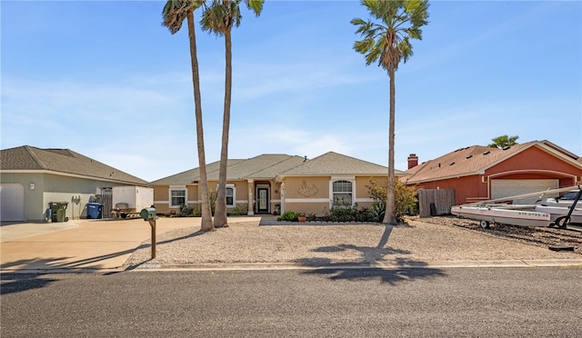 view of front of property featuring a garage, driveway, and stucco siding