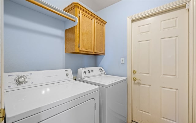 washroom with cabinet space and washing machine and clothes dryer