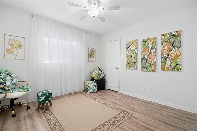 119 Misty Ln, Aransas Pass, TX 78336 - living area featuring wood finished floors, a ceiling fan, and baseboards