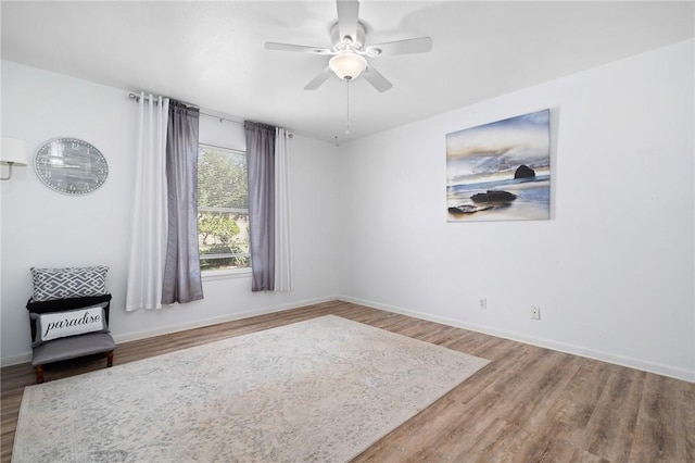 119 Misty Ln, Aransas Pass, TX 78336 - unfurnished room featuring wood finished floors, baseboards, and a ceiling fan