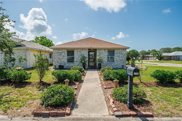 119 Misty Ln, Aransas Pass, TX 78336 - view of front of house with a front lawn and brick siding