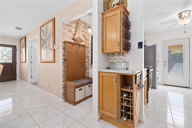 119 Misty Ln, Aransas Pass, TX 78336 - bar area featuring a ceiling fan, light marble finish floors, and freestanding refrigerator