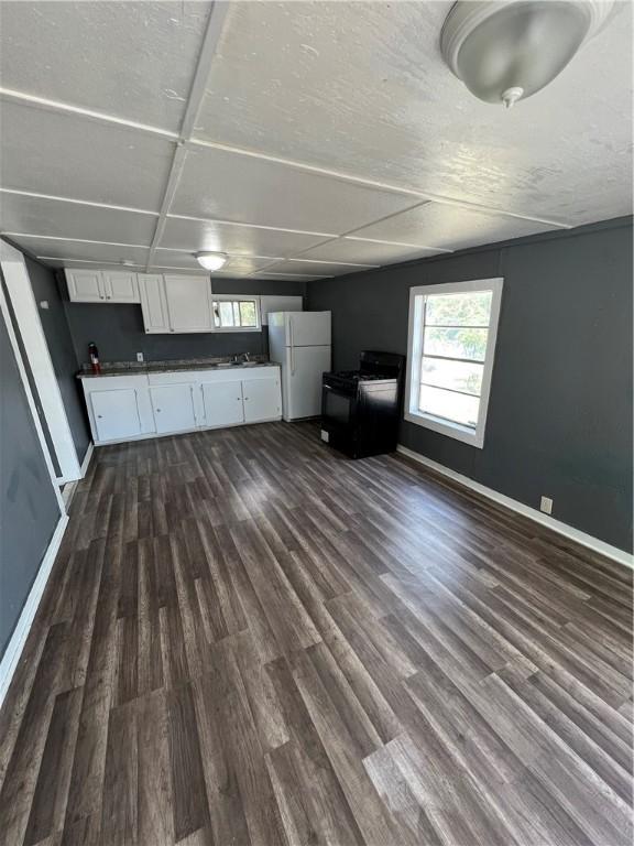 unfurnished living room featuring dark hardwood / wood-style floors