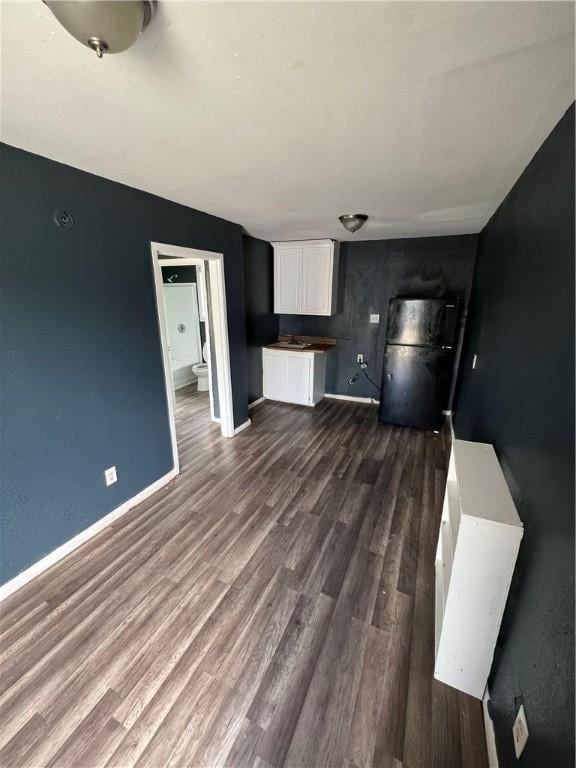 unfurnished living room featuring dark hardwood / wood-style floors