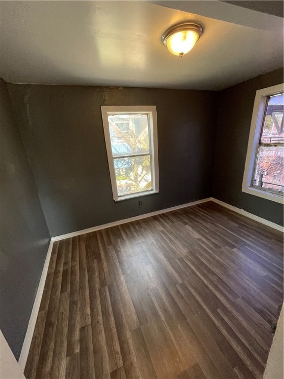 empty room featuring dark hardwood / wood-style flooring