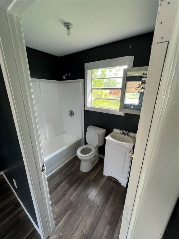 full bathroom with shower / washtub combination, hardwood / wood-style floors, vanity, and toilet