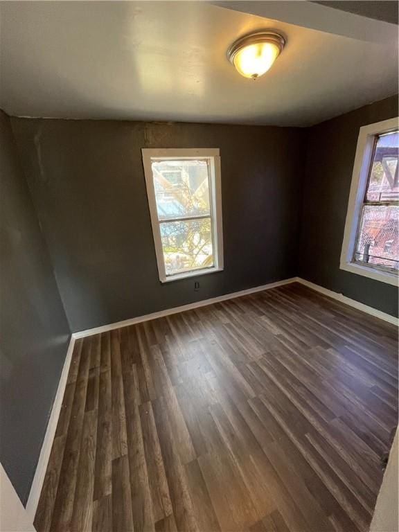 unfurnished room with dark hardwood / wood-style floors