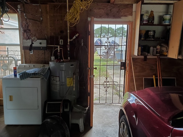 clothes washing area with washing machine and dryer and water heater