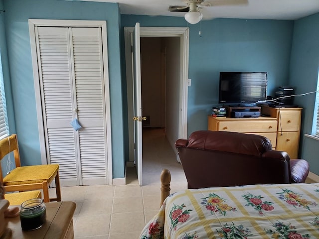 tiled bedroom featuring ceiling fan