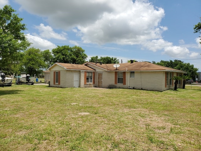 rear view of property with a yard