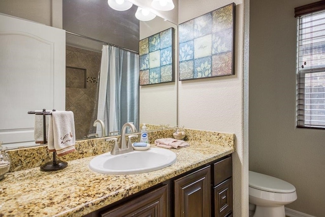 bathroom with a shower with shower curtain, a textured wall, vanity, and toilet