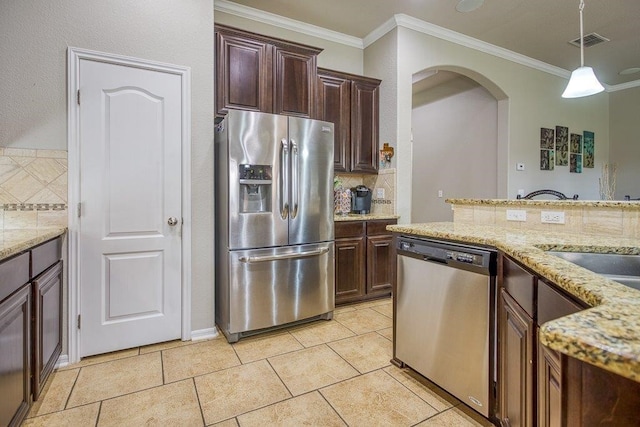 kitchen with stainless steel appliances, arched walkways, ornamental molding, and decorative backsplash