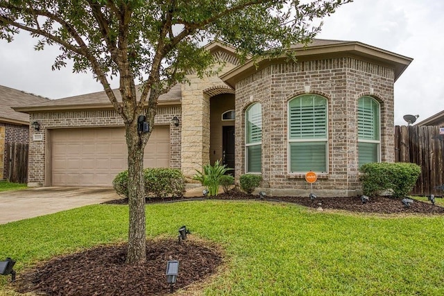 view of front of property with a garage, a front yard, concrete driveway, and brick siding