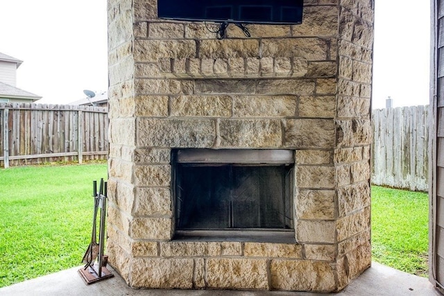 exterior details with fence and exterior fireplace