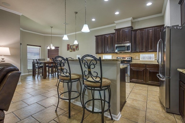 kitchen with a breakfast bar area, stainless steel appliances, dark brown cabinets, decorative backsplash, and a center island