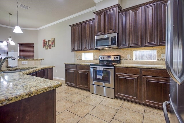 kitchen featuring decorative backsplash, stainless steel appliances, crown molding, pendant lighting, and a sink