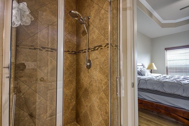 ensuite bathroom featuring a shower stall, ornamental molding, and ensuite bathroom