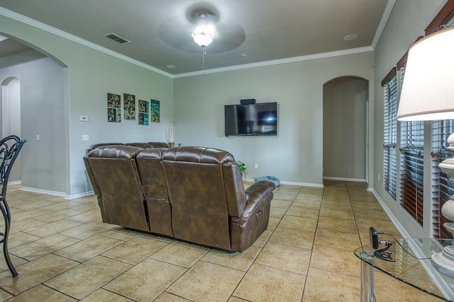 living room with baseboards, visible vents, arched walkways, crown molding, and light tile patterned flooring