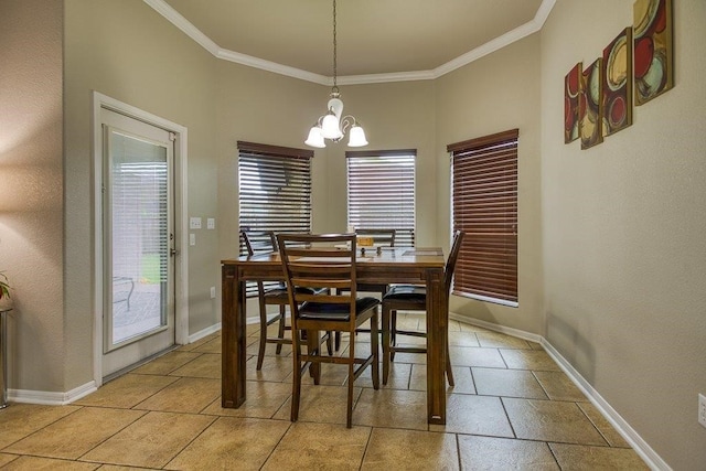 dining space featuring baseboards, a chandelier, and crown molding