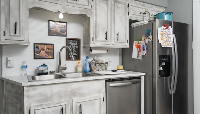 kitchen featuring sink, decorative backsplash, and appliances with stainless steel finishes