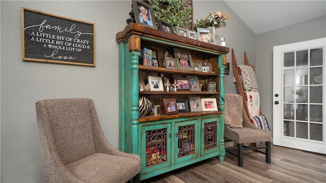 living area featuring hardwood / wood-style floors and vaulted ceiling