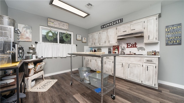 kitchen with dark wood-type flooring and white cabinetry