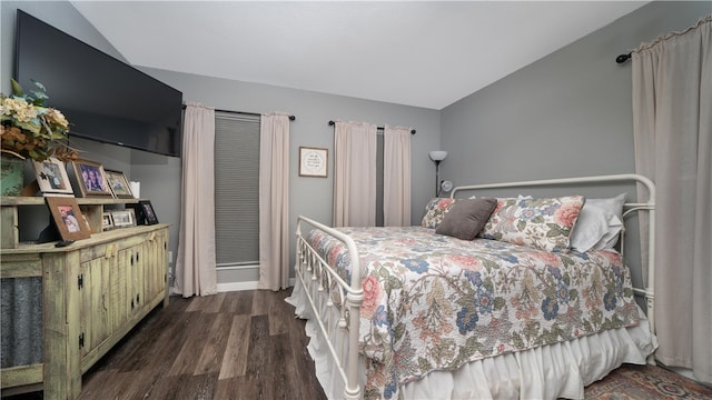 bedroom with dark hardwood / wood-style floors and vaulted ceiling