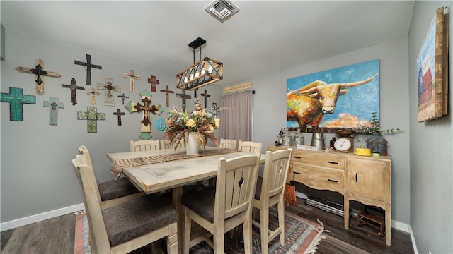 dining area featuring dark wood-type flooring