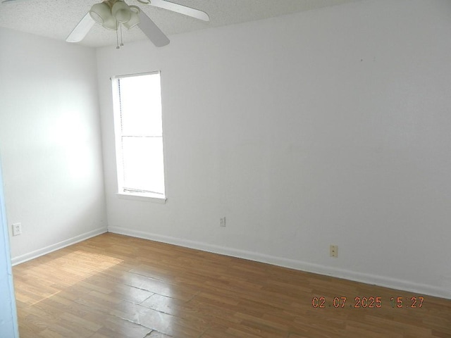 spare room with light hardwood / wood-style flooring and ceiling fan