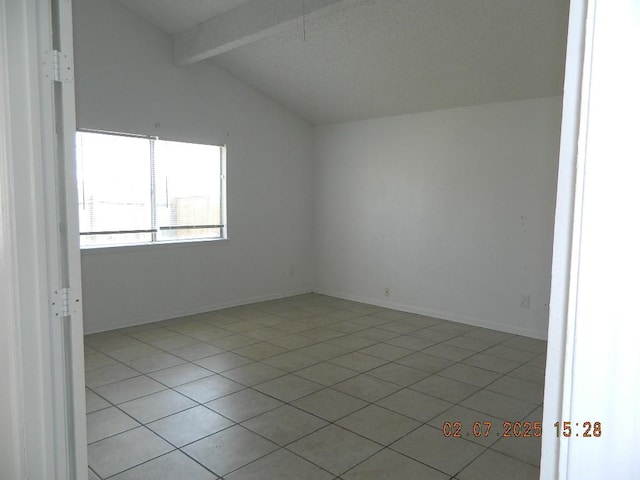 spare room featuring lofted ceiling with beams