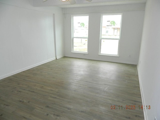 spare room featuring dark hardwood / wood-style floors and ceiling fan