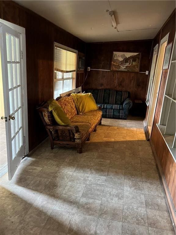 interior space with french doors and wood walls