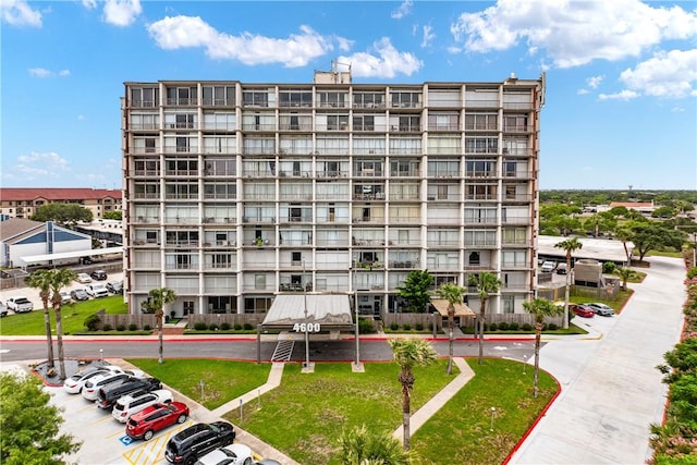 view of apartment building / complex with uncovered parking