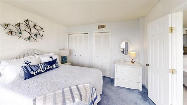 carpeted bedroom featuring two closets