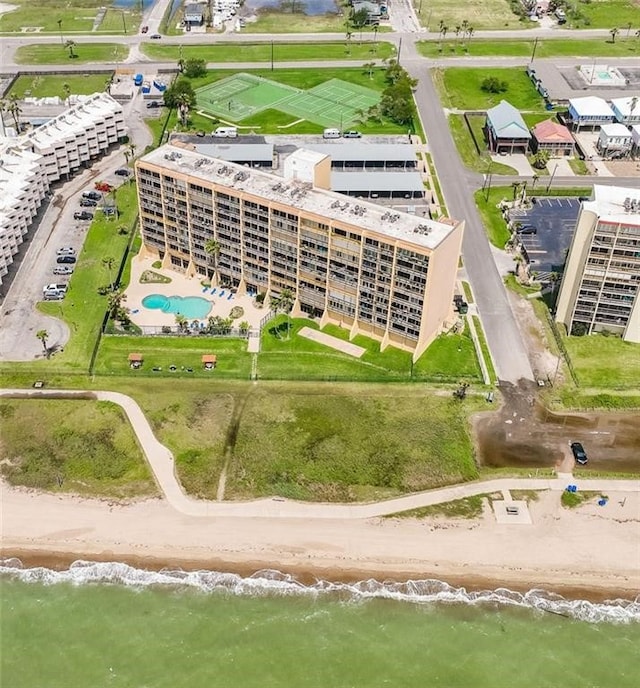 drone / aerial view with a water view and a beach view