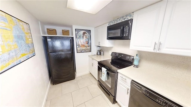 kitchen featuring black appliances, white cabinetry, and light tile patterned flooring